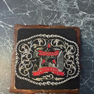 This item is a PBR (Professional Bull Riders) 20th Anniversary belt buckle.